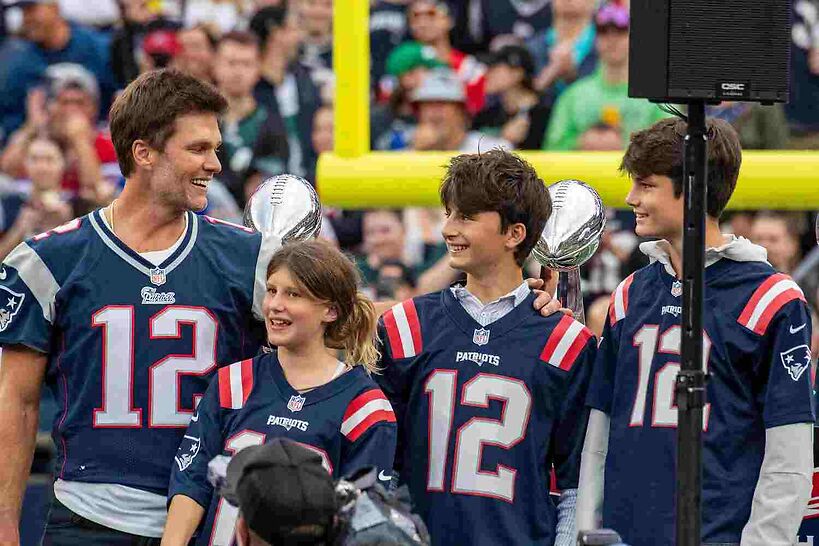Tom Brady stands with his children during a "Thank You" celebration honoring the former New England Patriots' quarterback